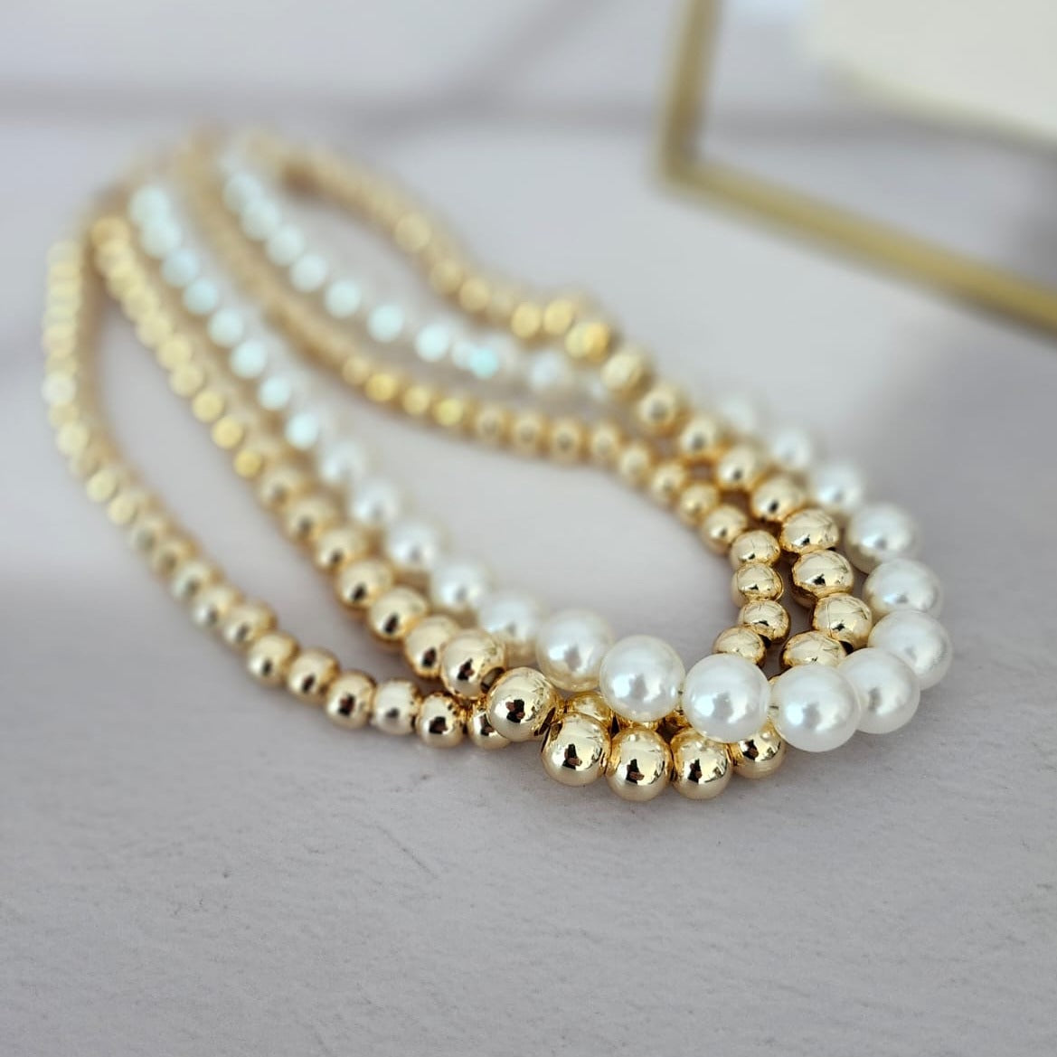 Dazzling 14K Steel Necklace The Finesse of Elegance with Triple Pearls and Gold Bead Details