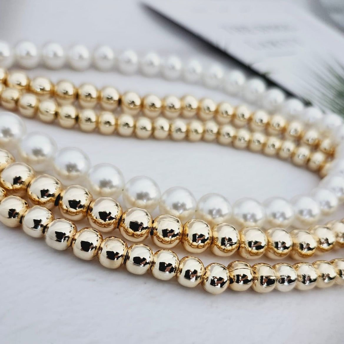 Dazzling 14K Steel Necklace The Finesse of Elegance with Triple Pearls and Gold Bead Details