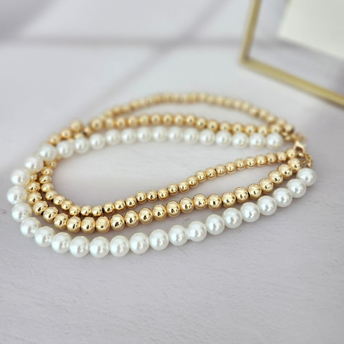 Dazzling 14K Steel Necklace The Finesse of Elegance with Triple Pearls and Gold Bead Details