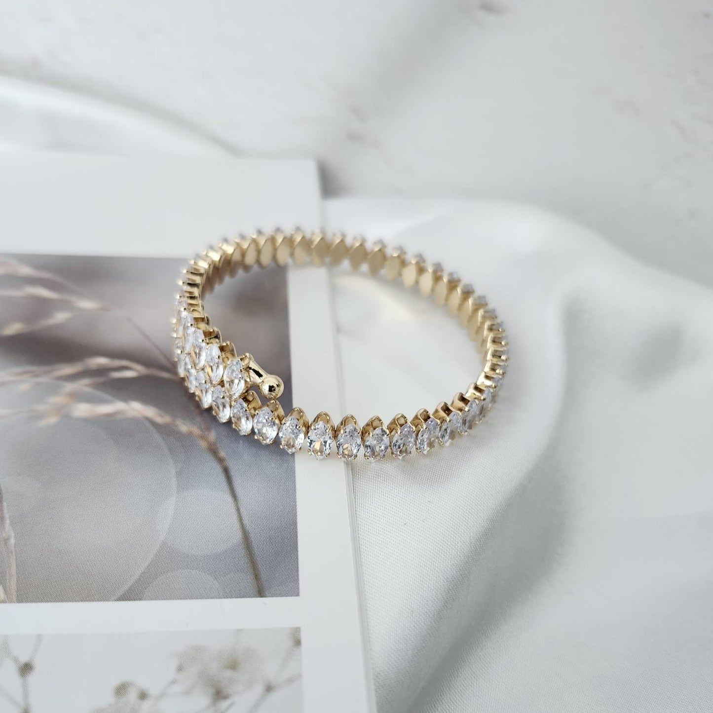 Illuminate with Elegance Stand Out with the Crystal-Studded Gold Bracelet